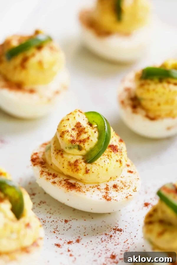 Close-up photo of Jalapeno Pimento Cheese Deviled Eggs garnished with jalapeno, a Southern twist on a classic appetizer.
