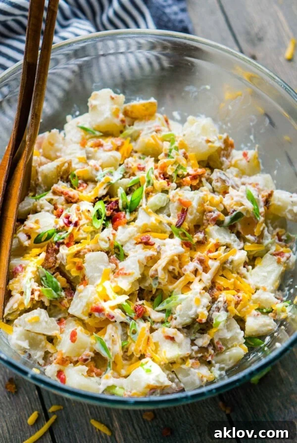 Loaded Baked Potato Salad with bacon, sour cream, chives, and cheddar cheese, ideal for potlucks and barbecues.