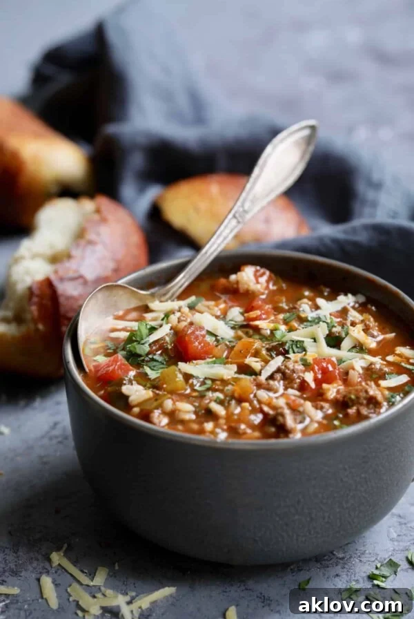 Photo of a bowl of Southwestern Stuffed Pepper Soup on blue background with bread, offering comfort with a spicy kick.