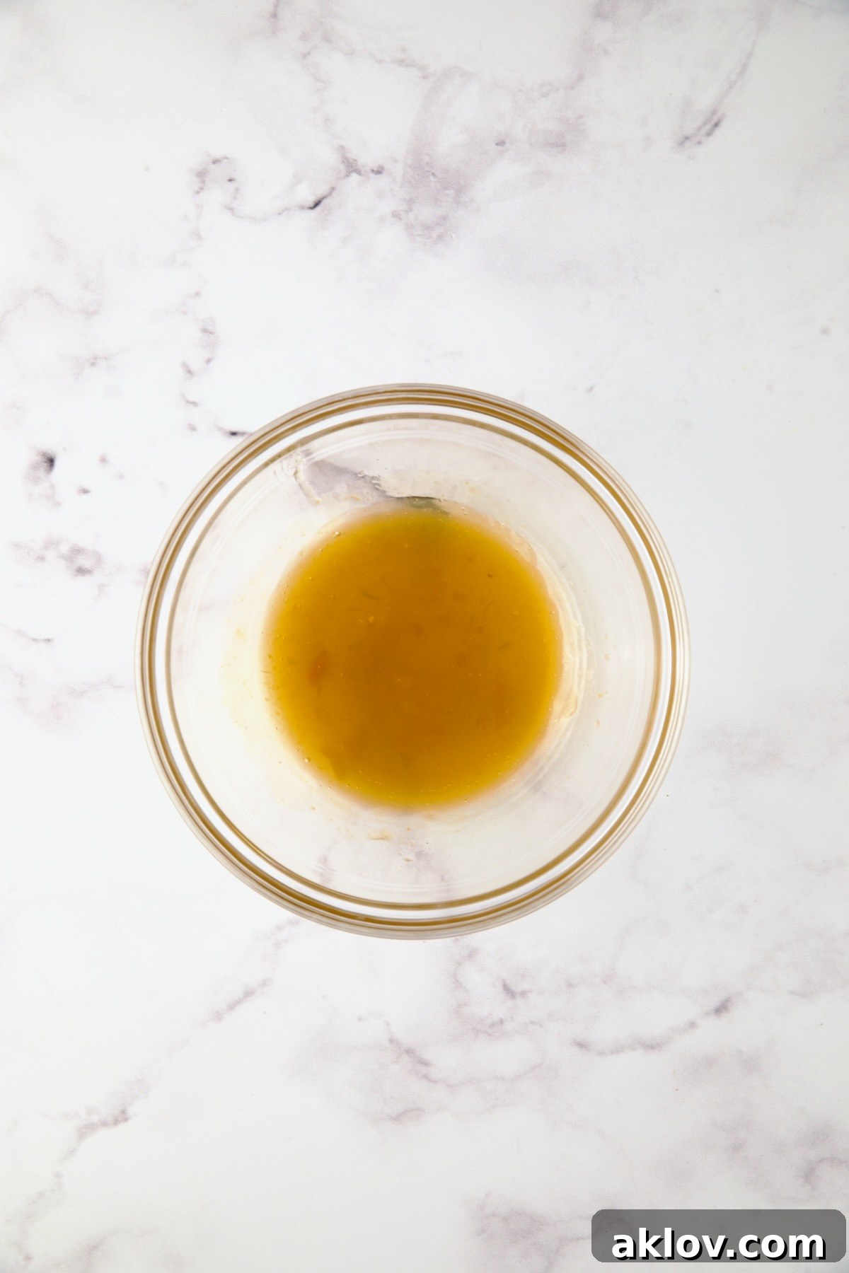 Apricot preserves and cider vinegar in glass bowl.
