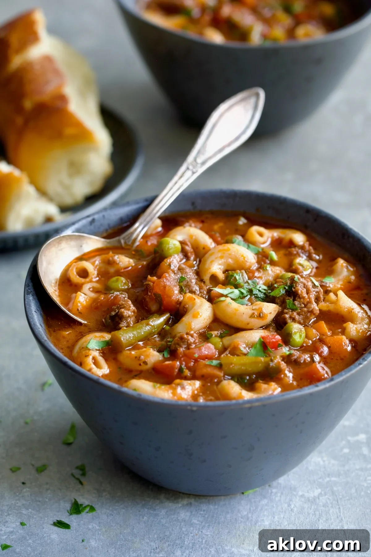 A bowl of comforting Hamburger Vegetable Soup with a spoon.