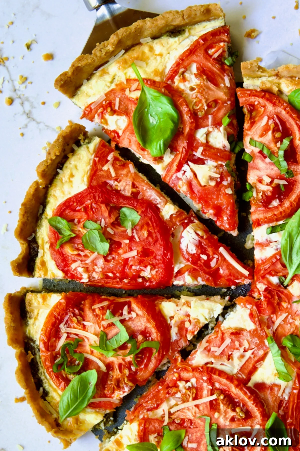 Tomato Tart with Ricotta and Cheese sliced into wedges and garnished with fresh basil leaves.