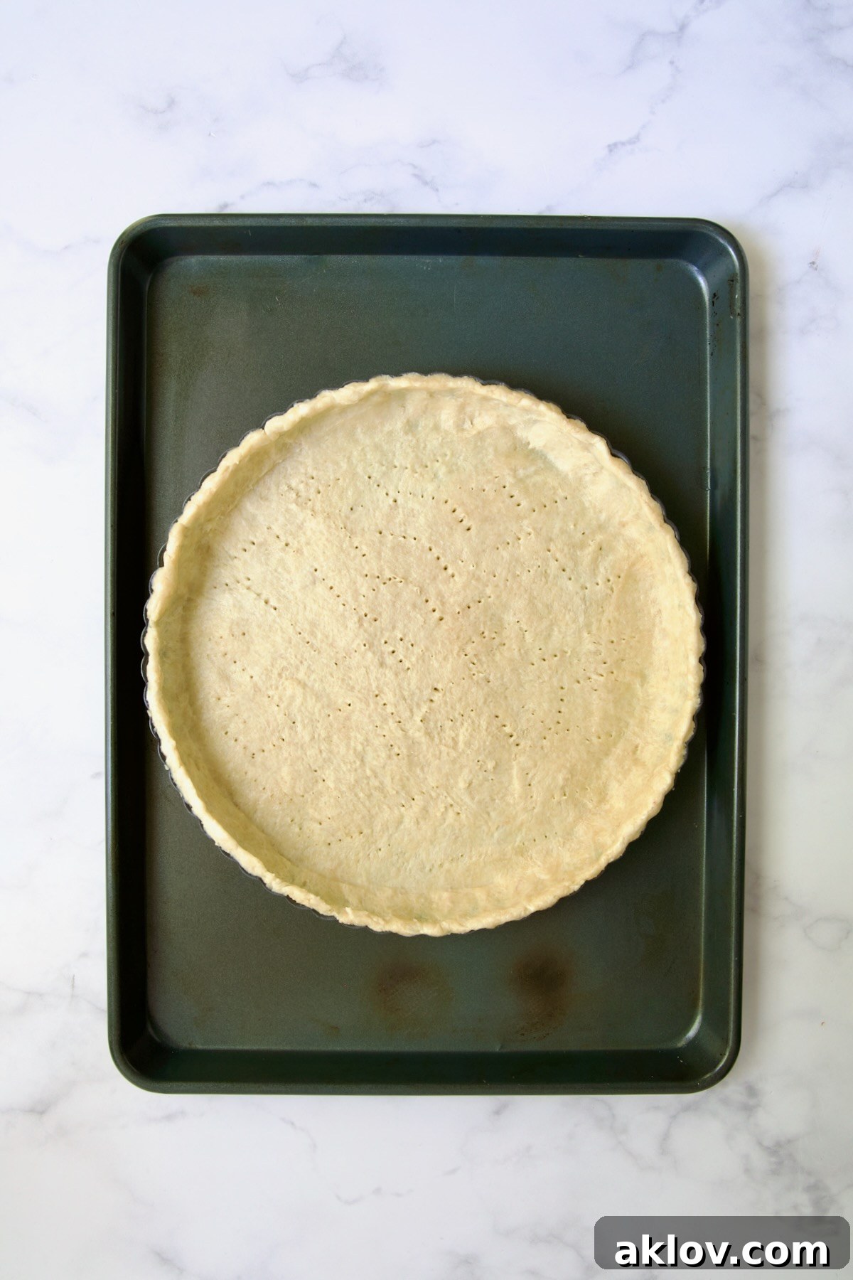 Tart crust on rimmed sheet pan before being blind baked.