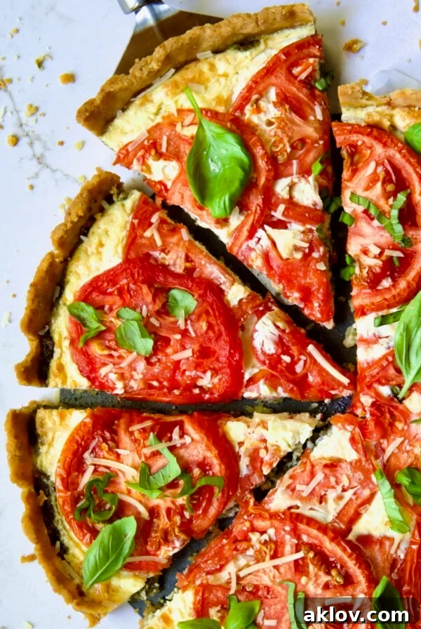 Tomato Tart with Ricotta and Cheese sliced into wedges and garnished with fresh basil leaves.