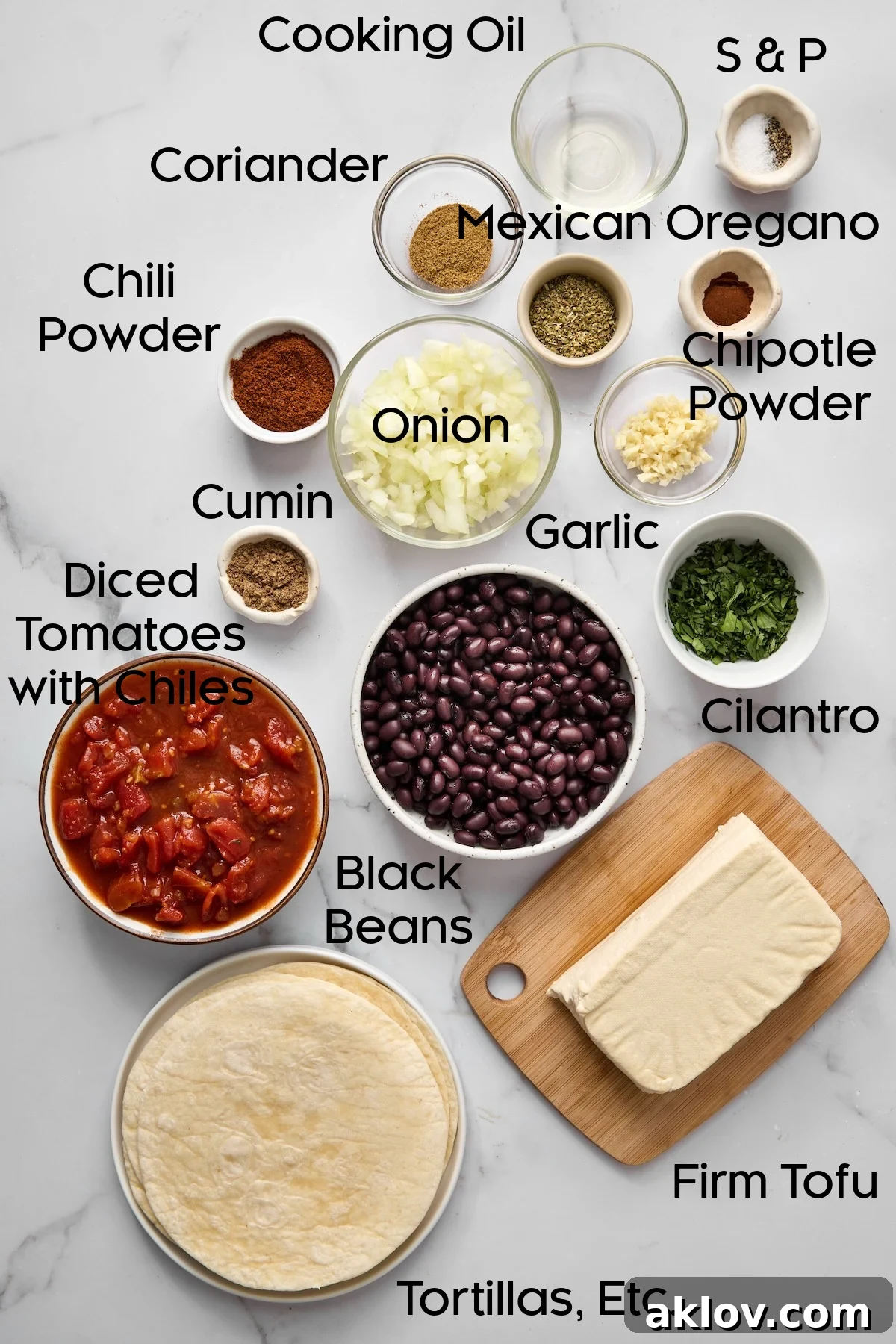 A beautifully arranged collection of fresh ingredients for Tofu Black Bean Tacos, displayed in various glass bowls.