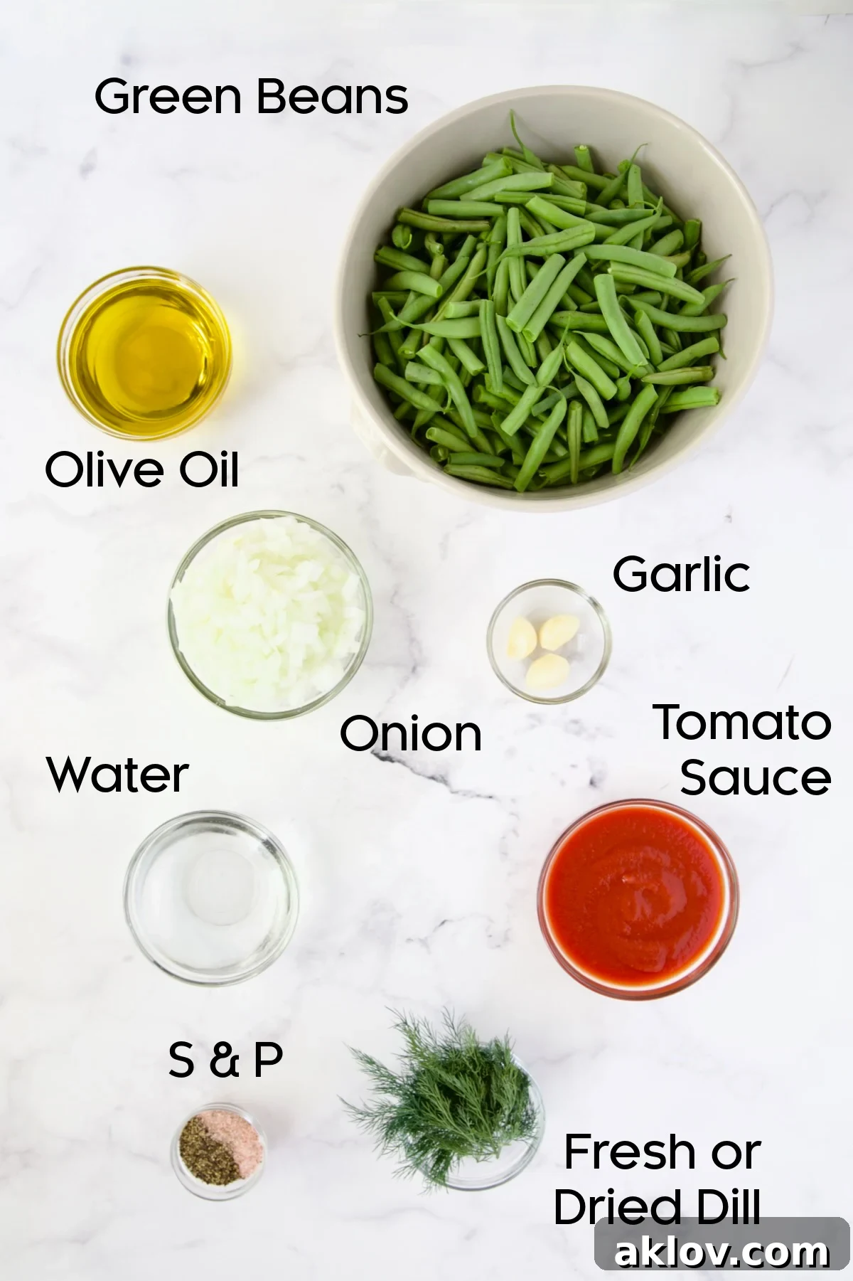 Individual bowls of ingredients for Greek Green Beans displayed on a kitchen countertop.