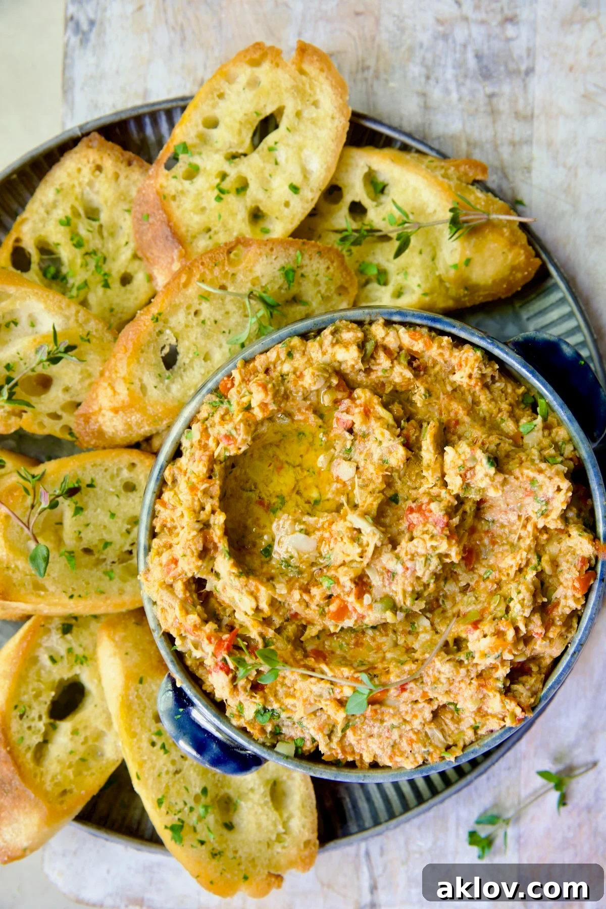 Artichoke Tapenade served with crostini on an elegant metal platter, ready for entertaining.
