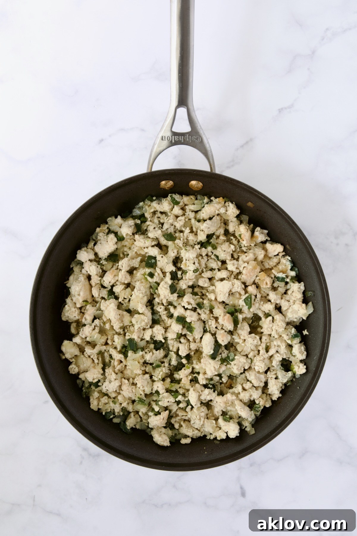 Cooked ground chicken, onions and poblano peppers in nonstick skillet.