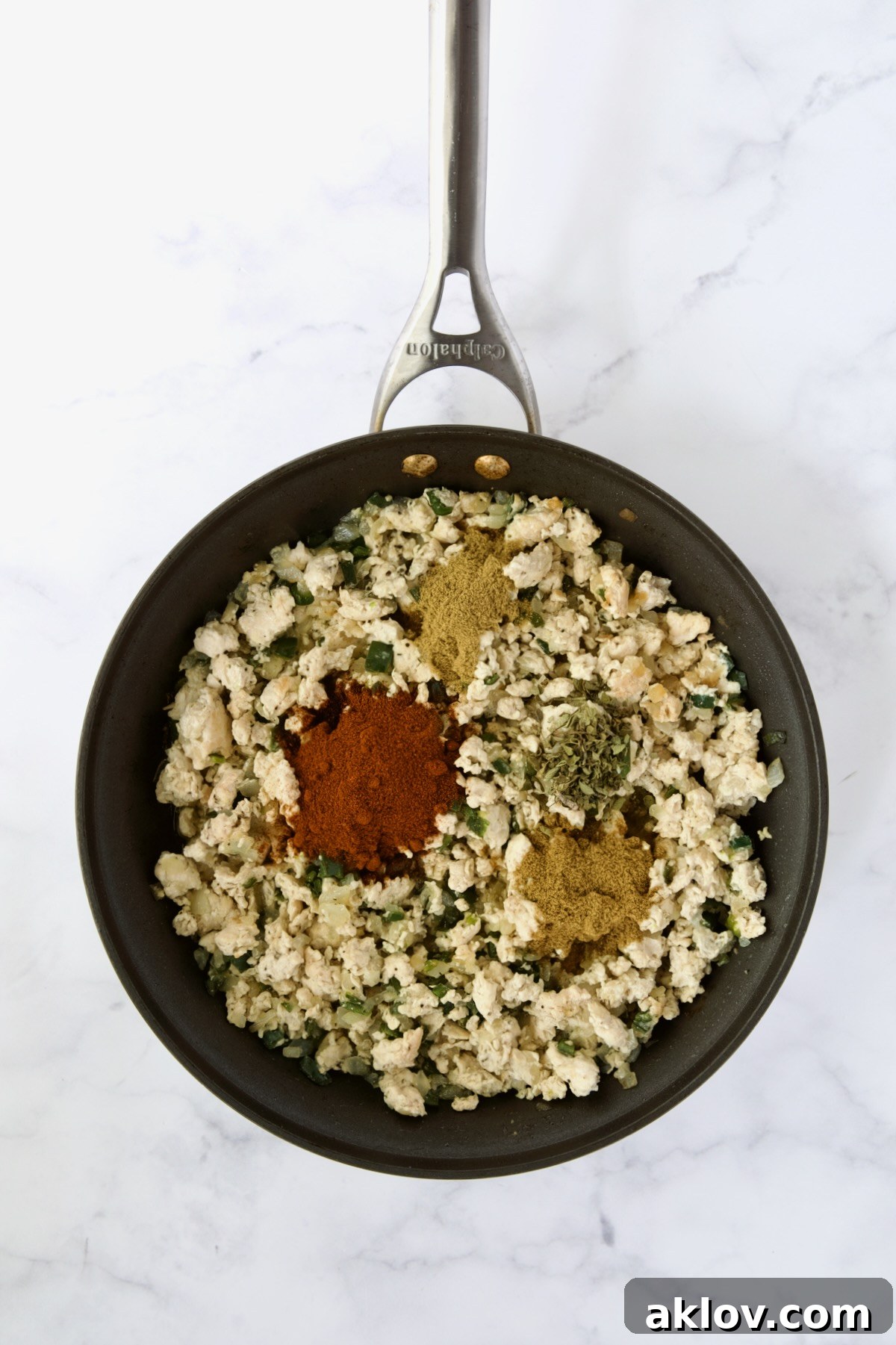 Cooked ground chicken, onions and poblanos with chili powder, cumin, coriander and oregano added in nonstick skillet.