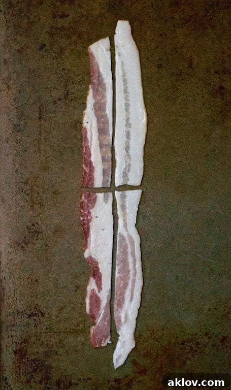 Photo of a strip of bacon cut into four "mini" slices for garnish.