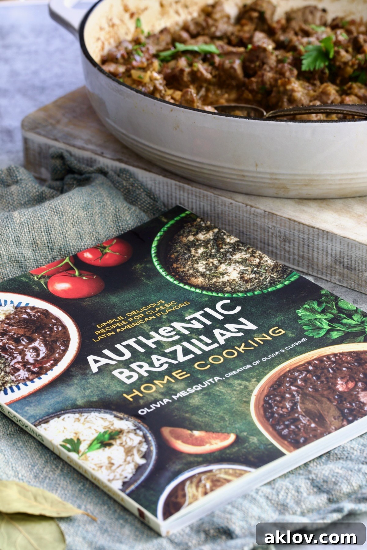 A close-up view of the Authentic Brazilian Home Cooking cookbook with an elegant presentation of beef tips, highlighting the rich cultural context of the recipes.