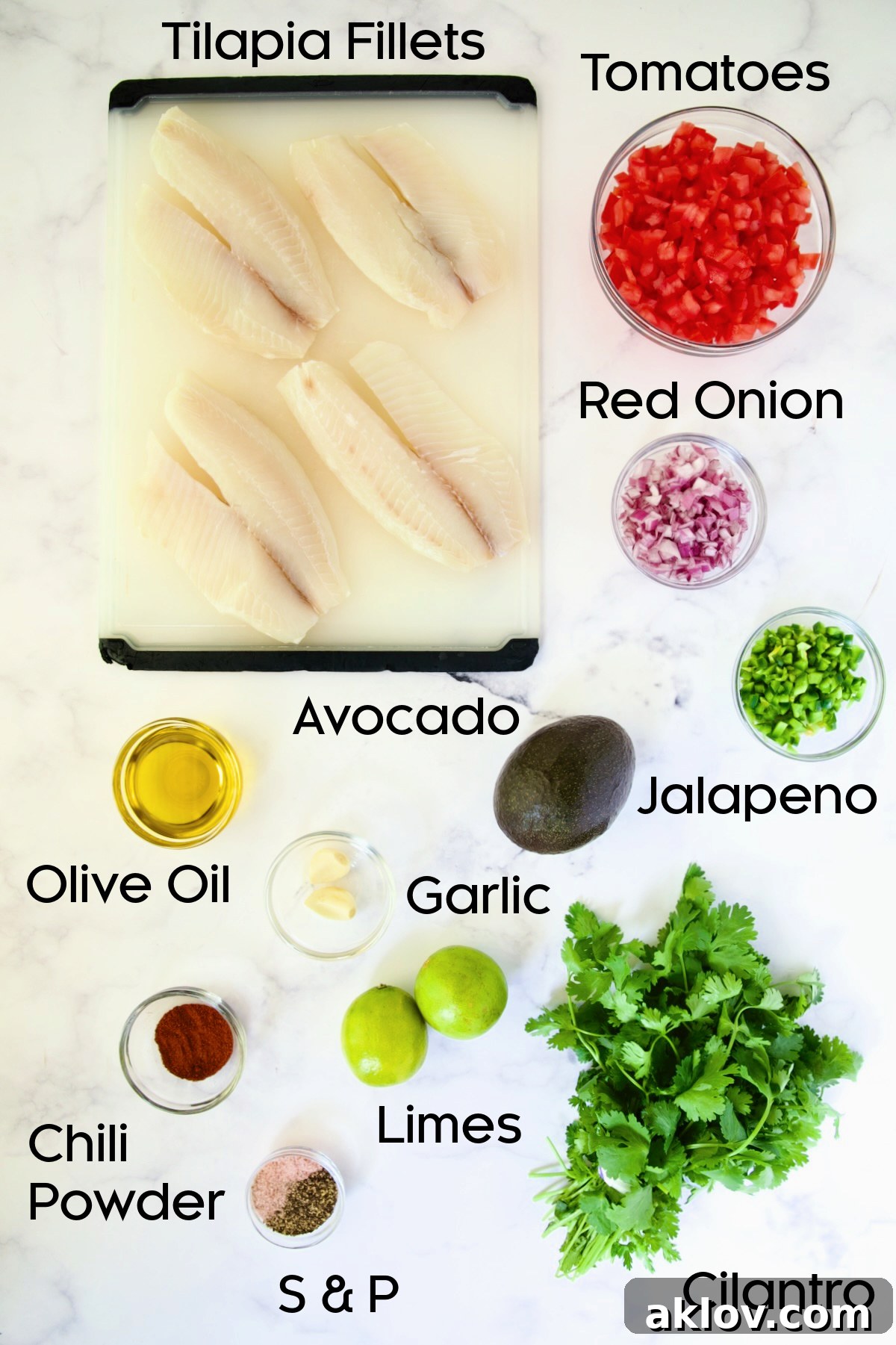 Ingredients for Grilled Tilapia with Tomato - Avocado Salsa laid out on a marble countertop.