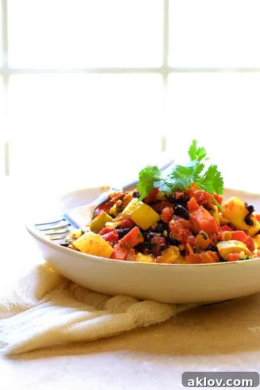 Spicy Roasted Vegetable and Black Bean Stew with Polenta artfully presented on burlap fabric, with a soft window light in the background.