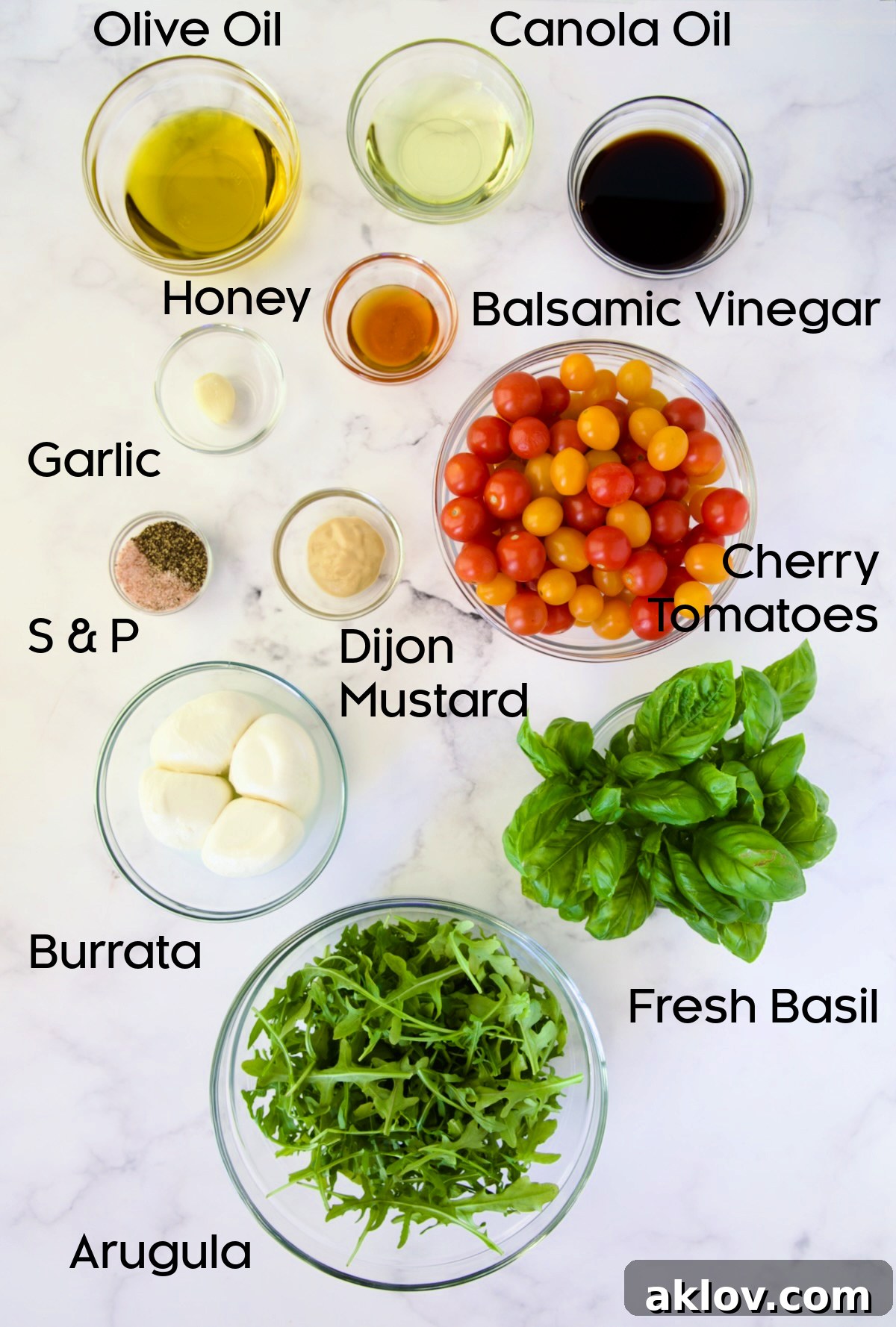 Creamy Burrata Caprese with Sweet Roasted Cherry Tomatoes 4 Fresh ingredients laid out for Burrata Caprese Salad, including cherry tomatoes, burrata, basil, arugula, and dressing components.