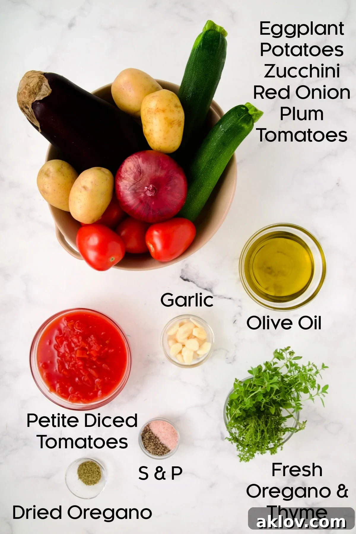 Ingredients for Briam (Greek Roast Vegetables) with the vegetables in colander and remaining ingredients in glass bowls.