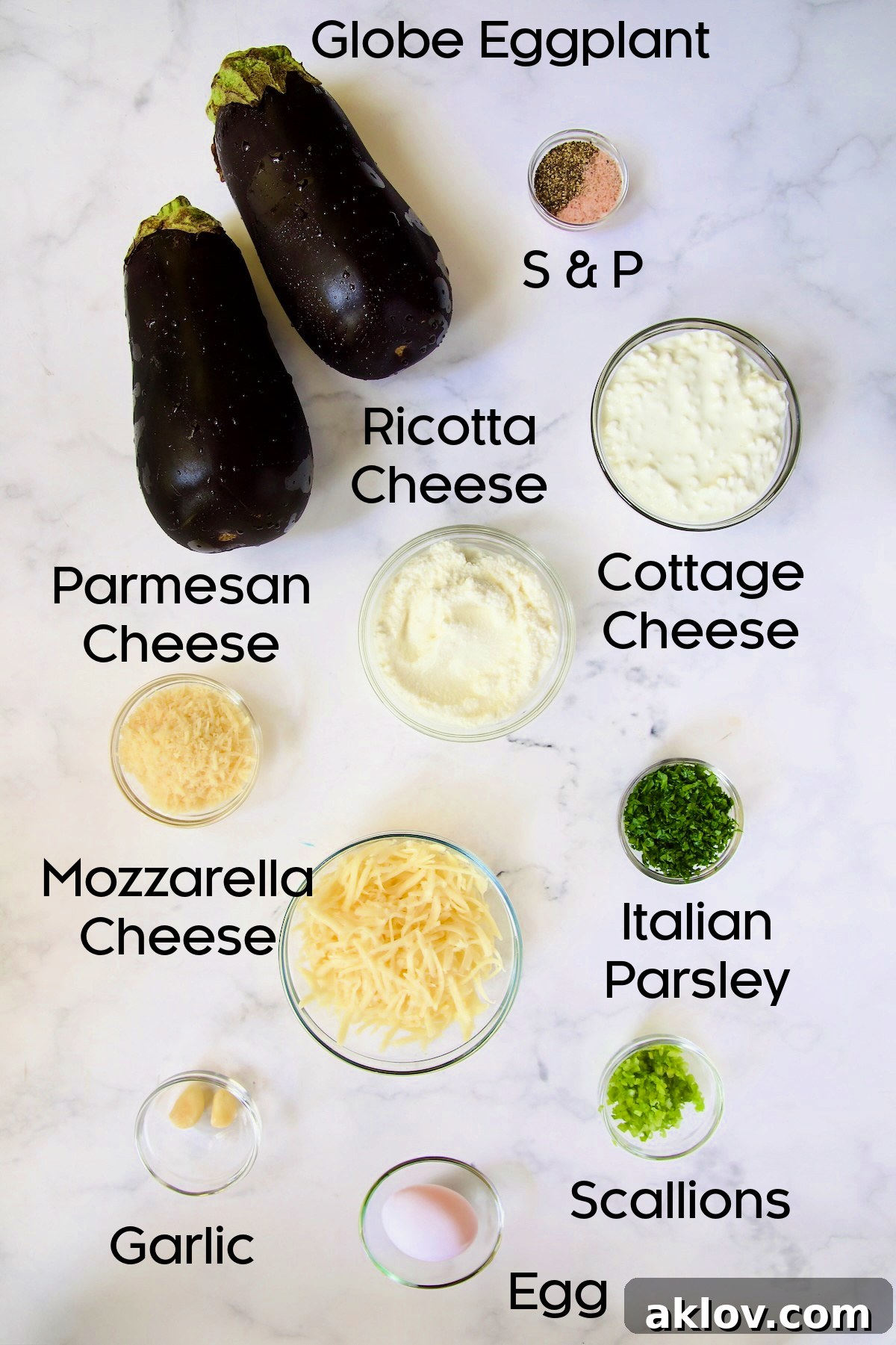 Ingredients for the filling for Four-Cheese Eggplant Rollatini in glass bowls on marble countertop.