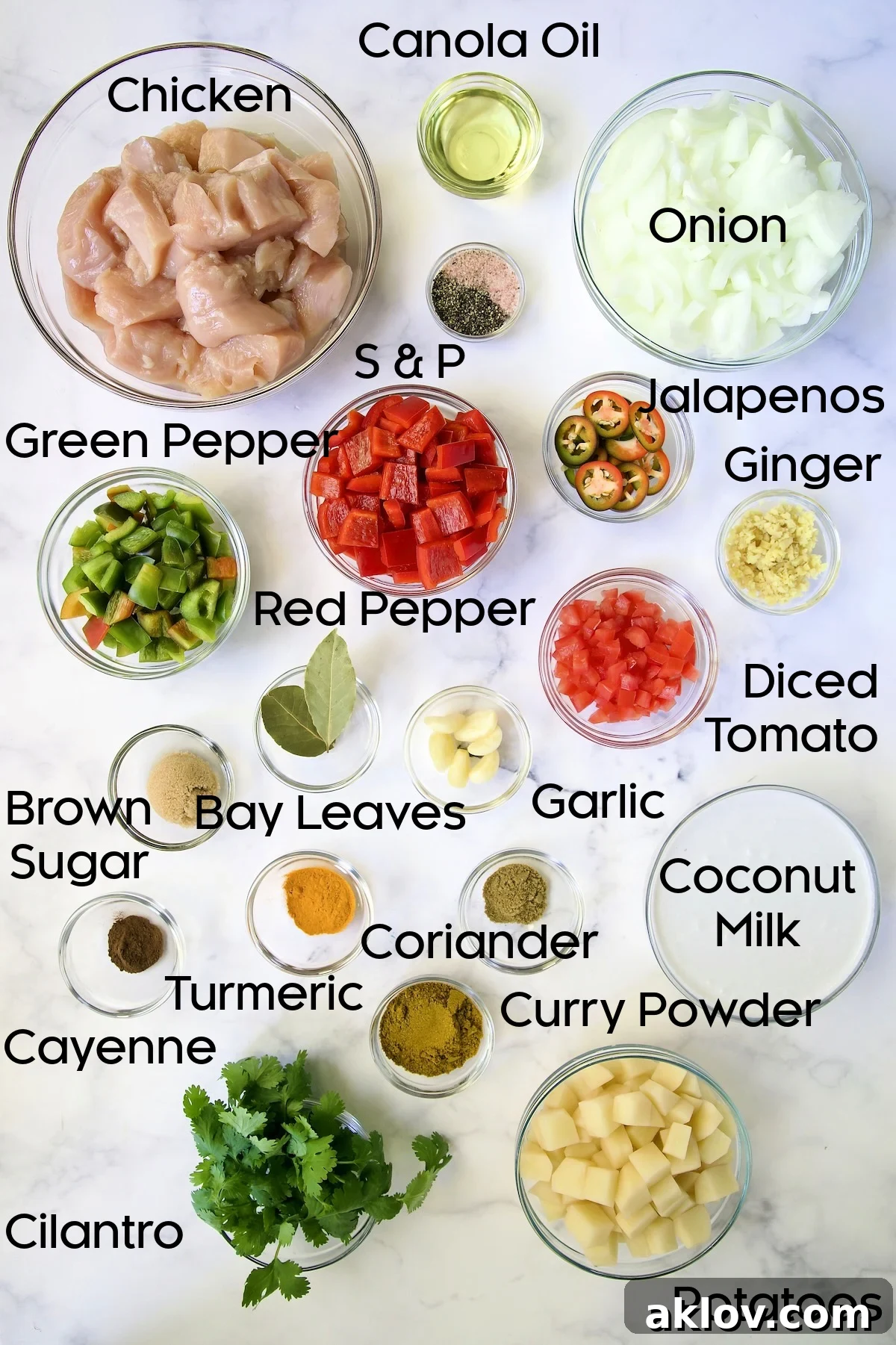 Comforting Chicken Potato Curry 4 A selection of fresh ingredients for Chicken and Potato Curry, meticulously arranged in glass bowls, including vibrant vegetables and aromatic spices.