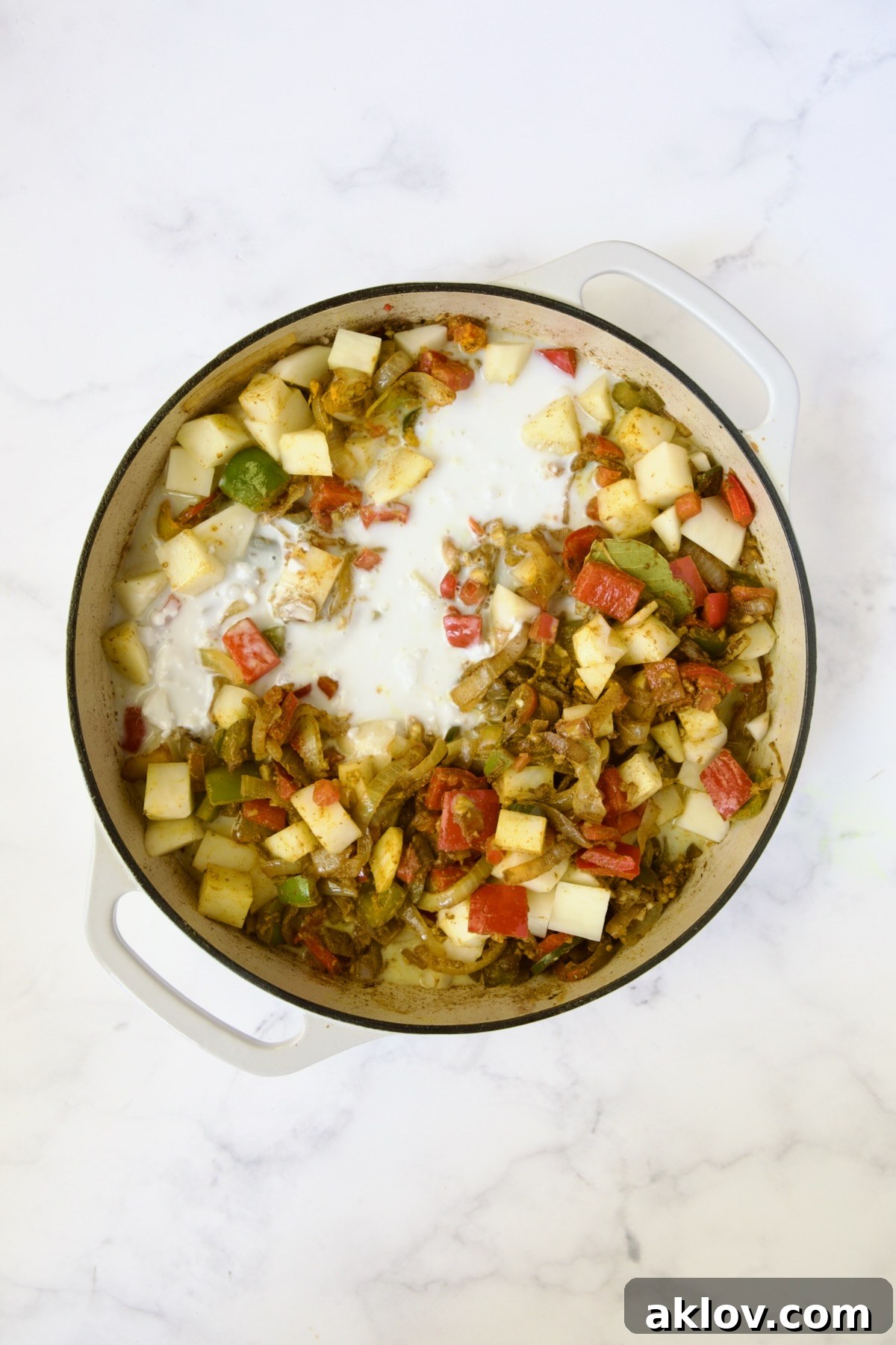 Coconut milk added to cooked vegetables and potatoes.