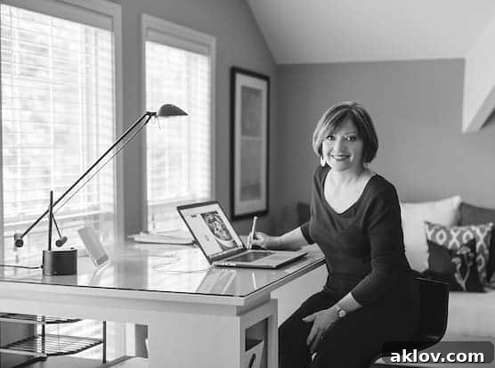 Photo of Carol Borchardt sitting at her desk in front of a computer.