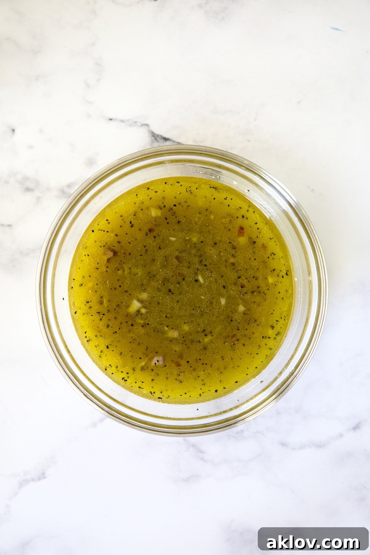 Zingy Shaved Brussels Salad 6 The perfectly emulsified and seasoned dressing for Shaved Brussels Sprouts Salad, glistening in a glass bowl, ready to unite the salad ingredients.