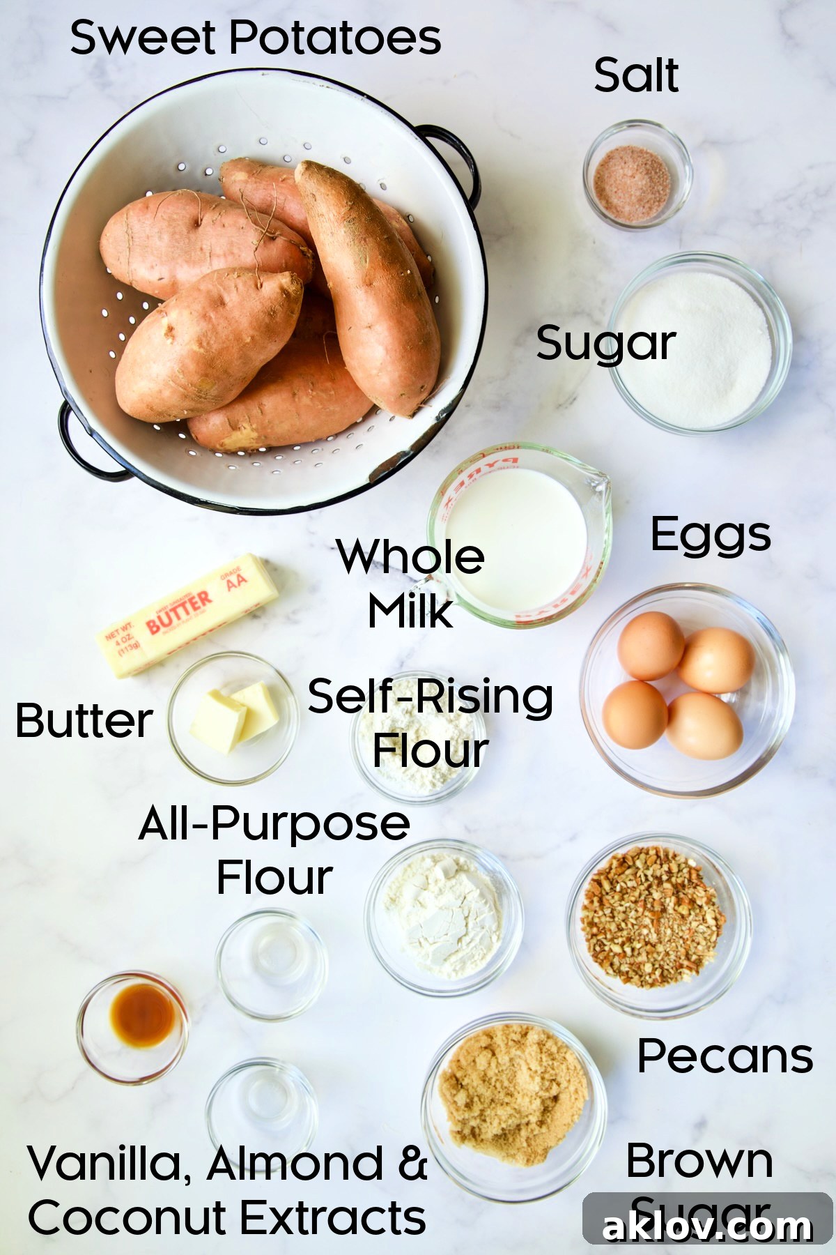 Ingredients for Sweet Potato Souffle laid out in glass bowls, including sweet potatoes, butter, eggs, milk, flour, and extracts.