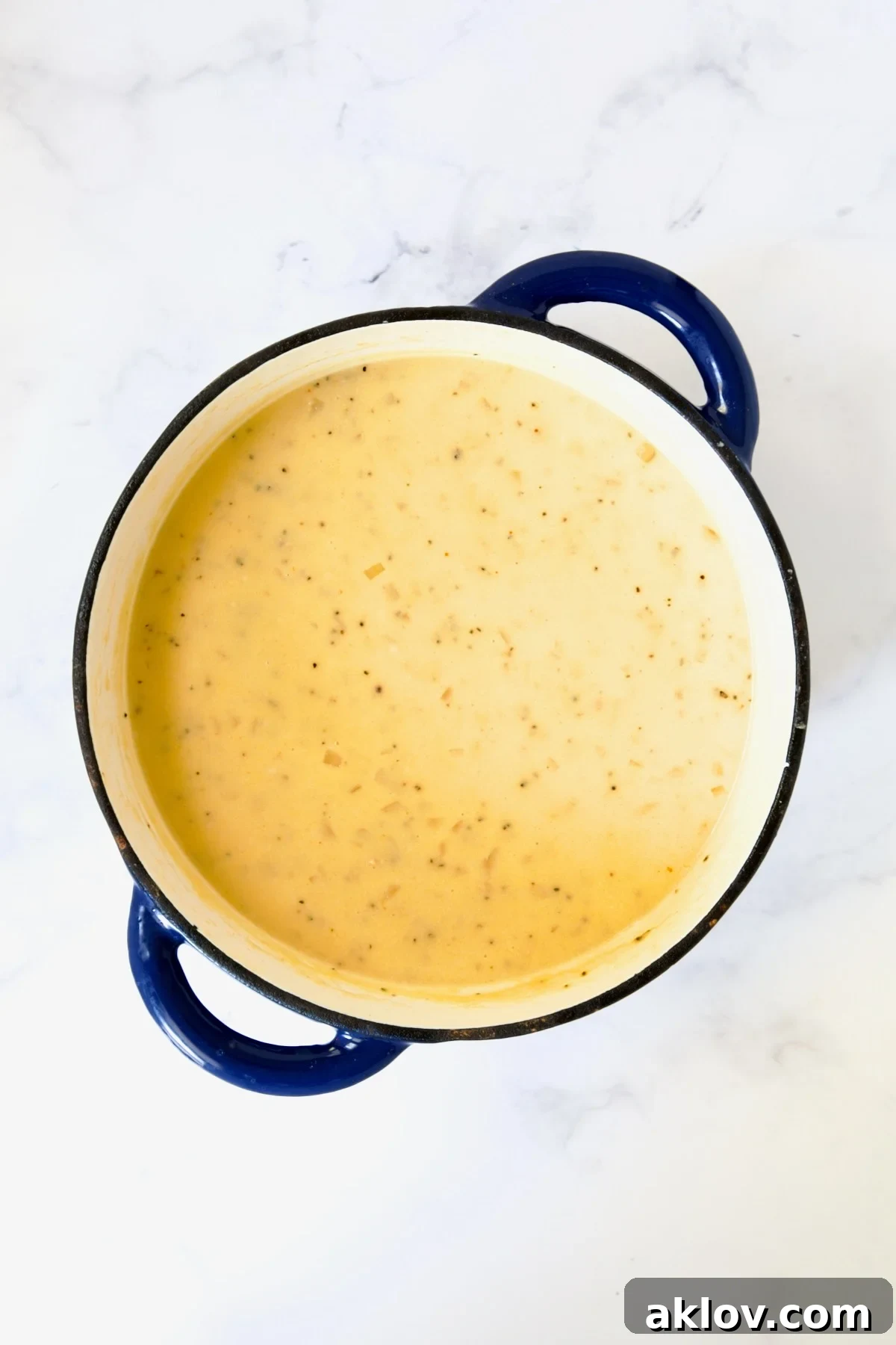Cheddar Bacon Potato Soup in blue Dutch oven.