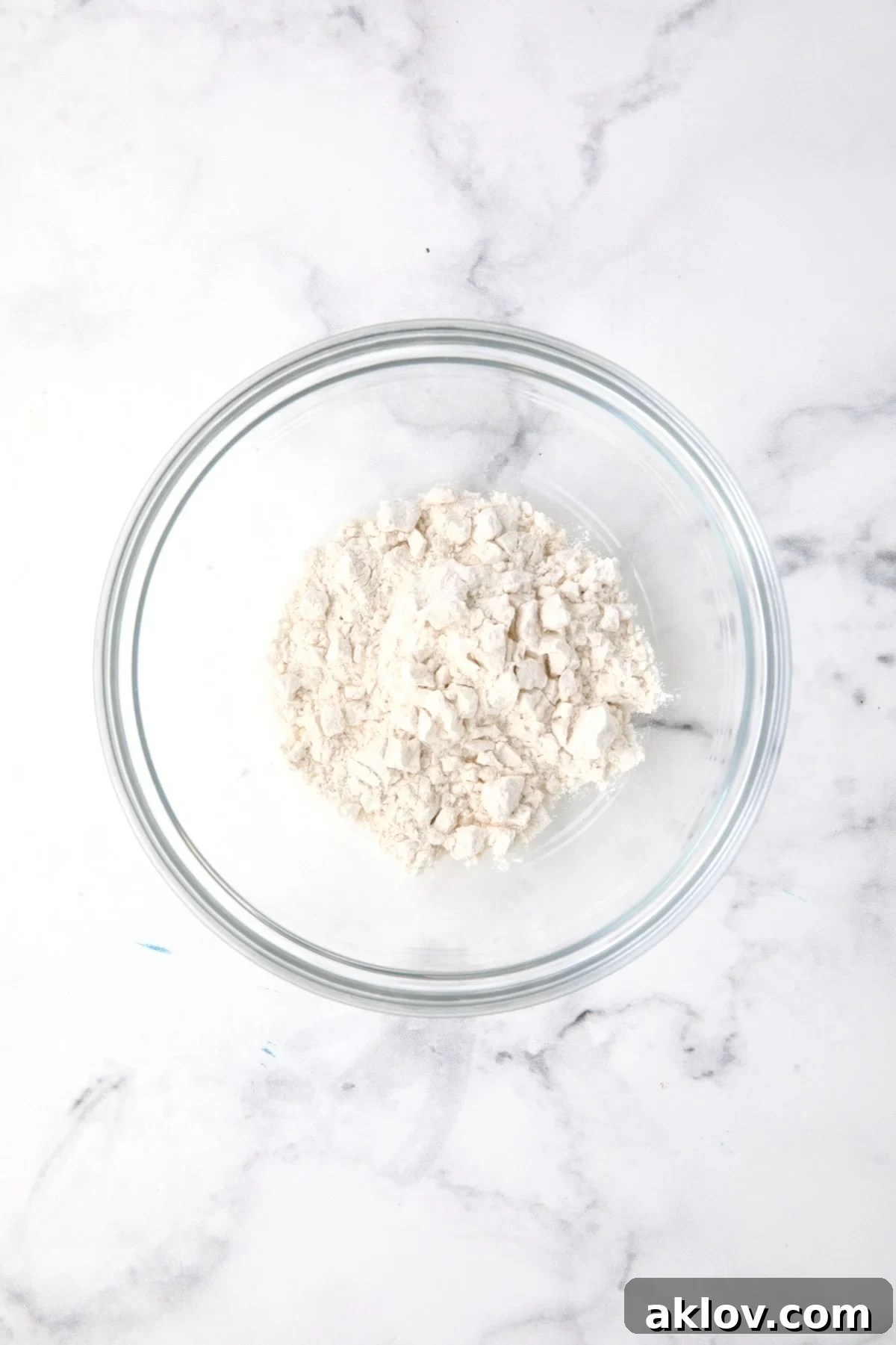 All-purpose flour measured precisely in a clear glass bowl.