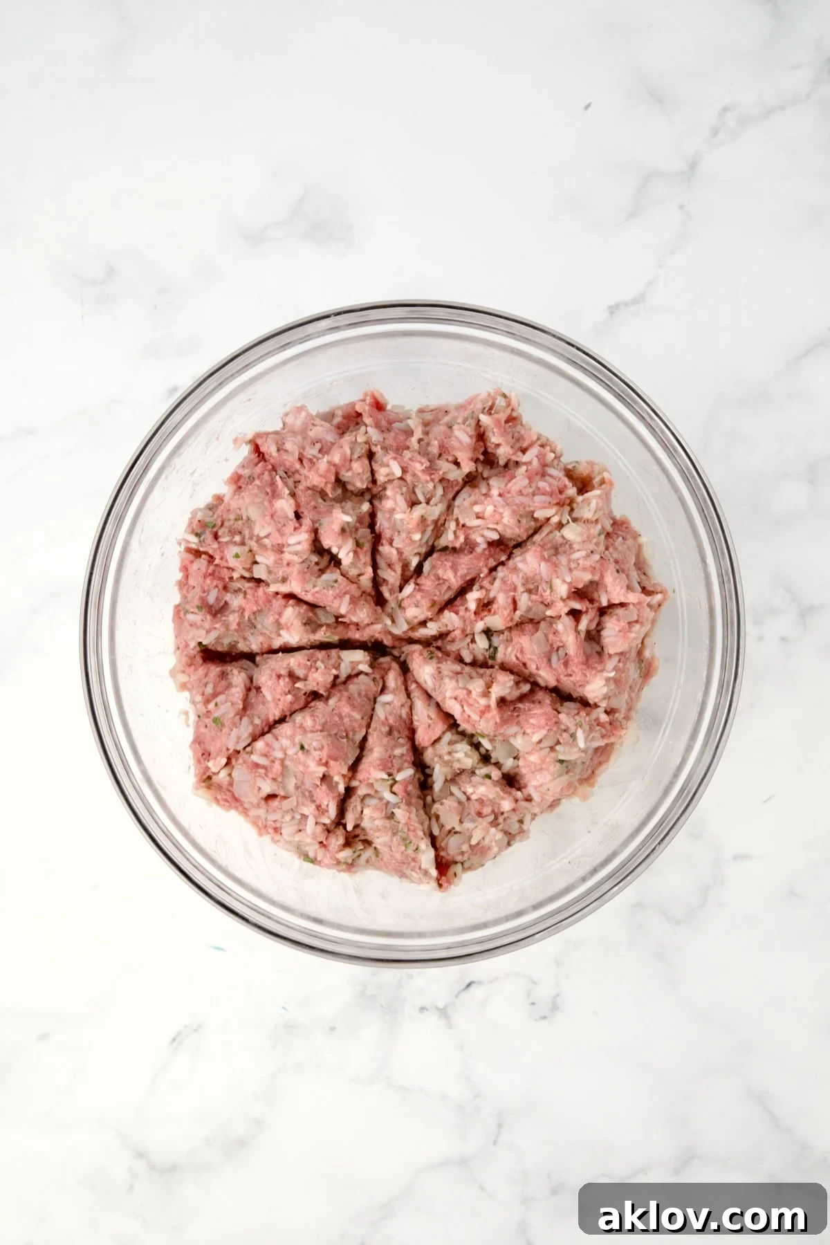Filling for cabbage rolls in glass bowl divided into 12 sections.