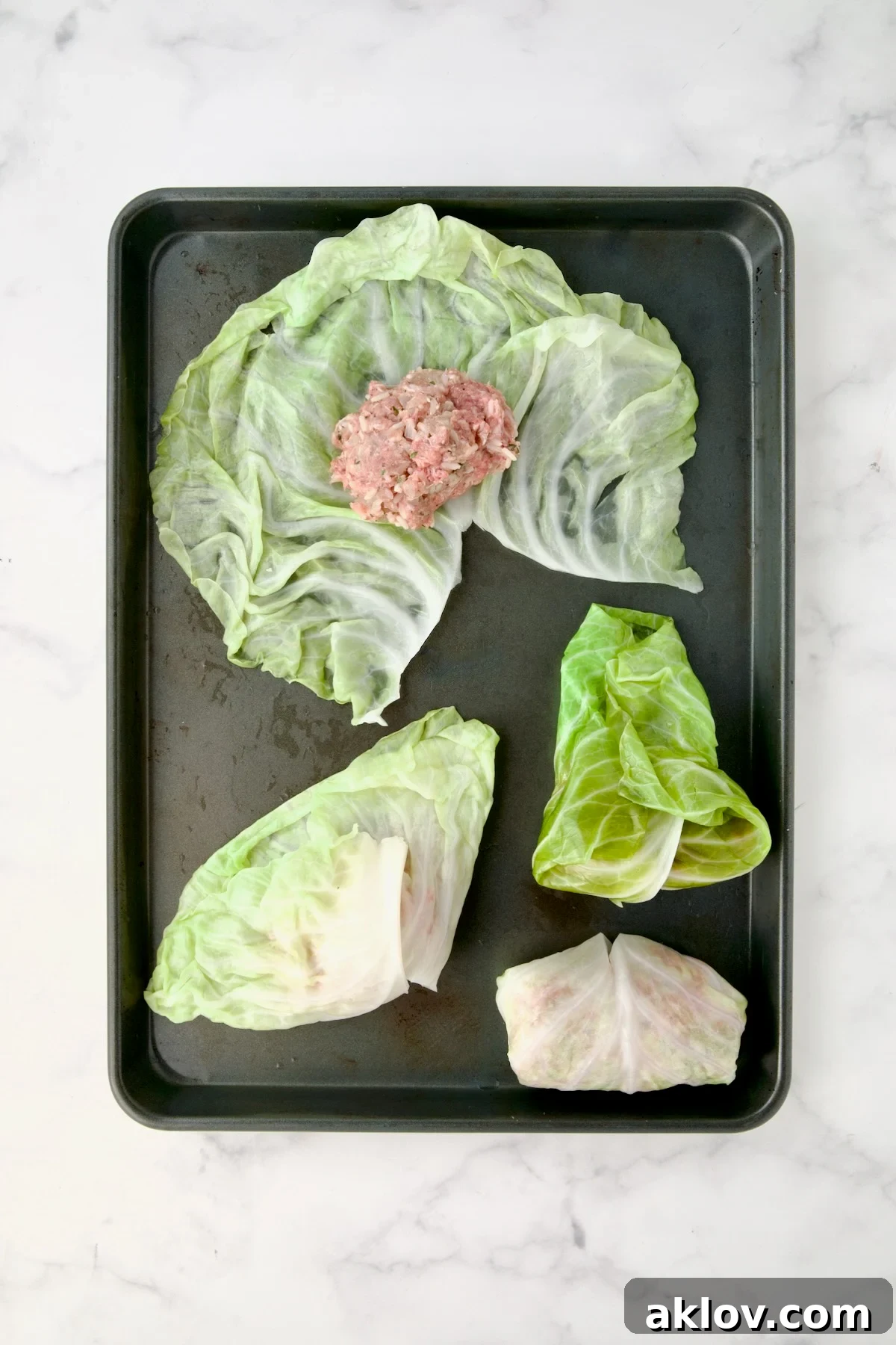 Steps demonstrating how to fill cabbage rolls: One unrolled with filling, one with bottom flaps brought over filling, another with sides tucked in and one fully rolled.