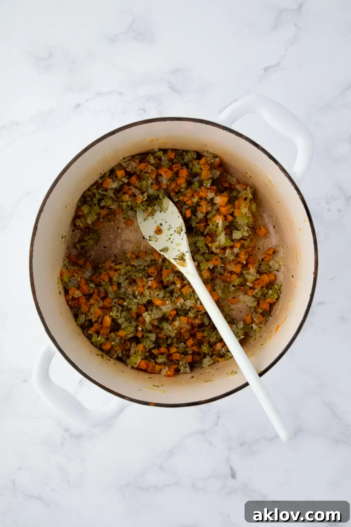 Garlic and herbs stirred into the cooked vegetables, releasing their aroma.