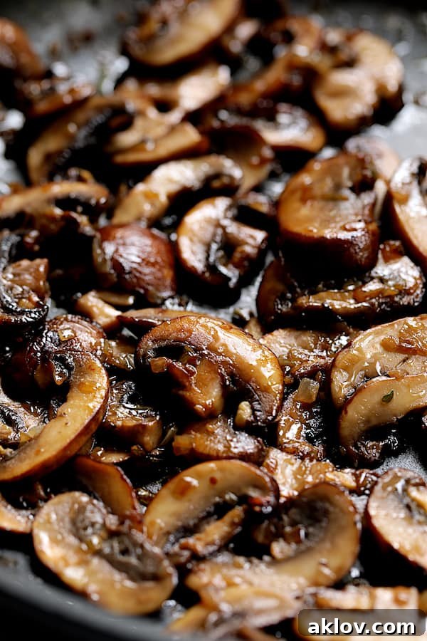 Close-up shot of browned mushrooms in skillet for Turkey Scallopini