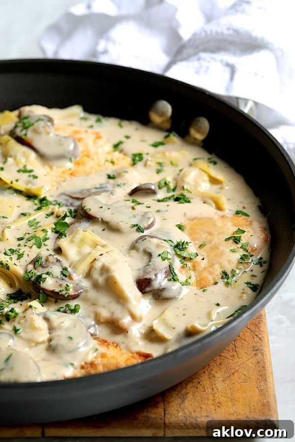 Turkey Scallopini in Sherry Cream Sauce with Mushrooms and Artichoke Hearts - Straight-on close-up shot of dish in skillet