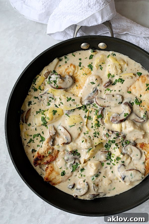 Turkey Scallopini in Sherry Cream Sauce with Mushrooms and Artichokes - Overhead close-up shot of finished dish in skillet