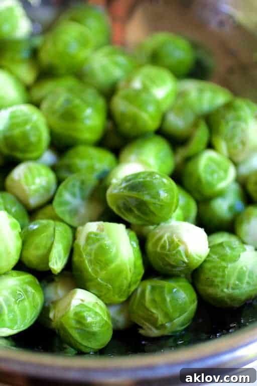 Photo of freshly trimmed Brussels sprouts in stainless steel colander.