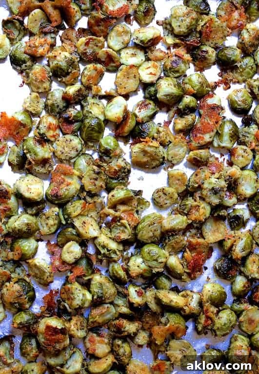 Photo of cooked Lemon Parmesan Crusted Brussels Sprouts on baking sheet.