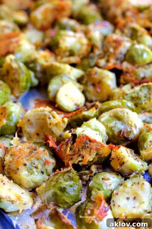Close-up photo of Lemon Parmesan Crusted Brussels Sprouts on baking sheet after roasting.