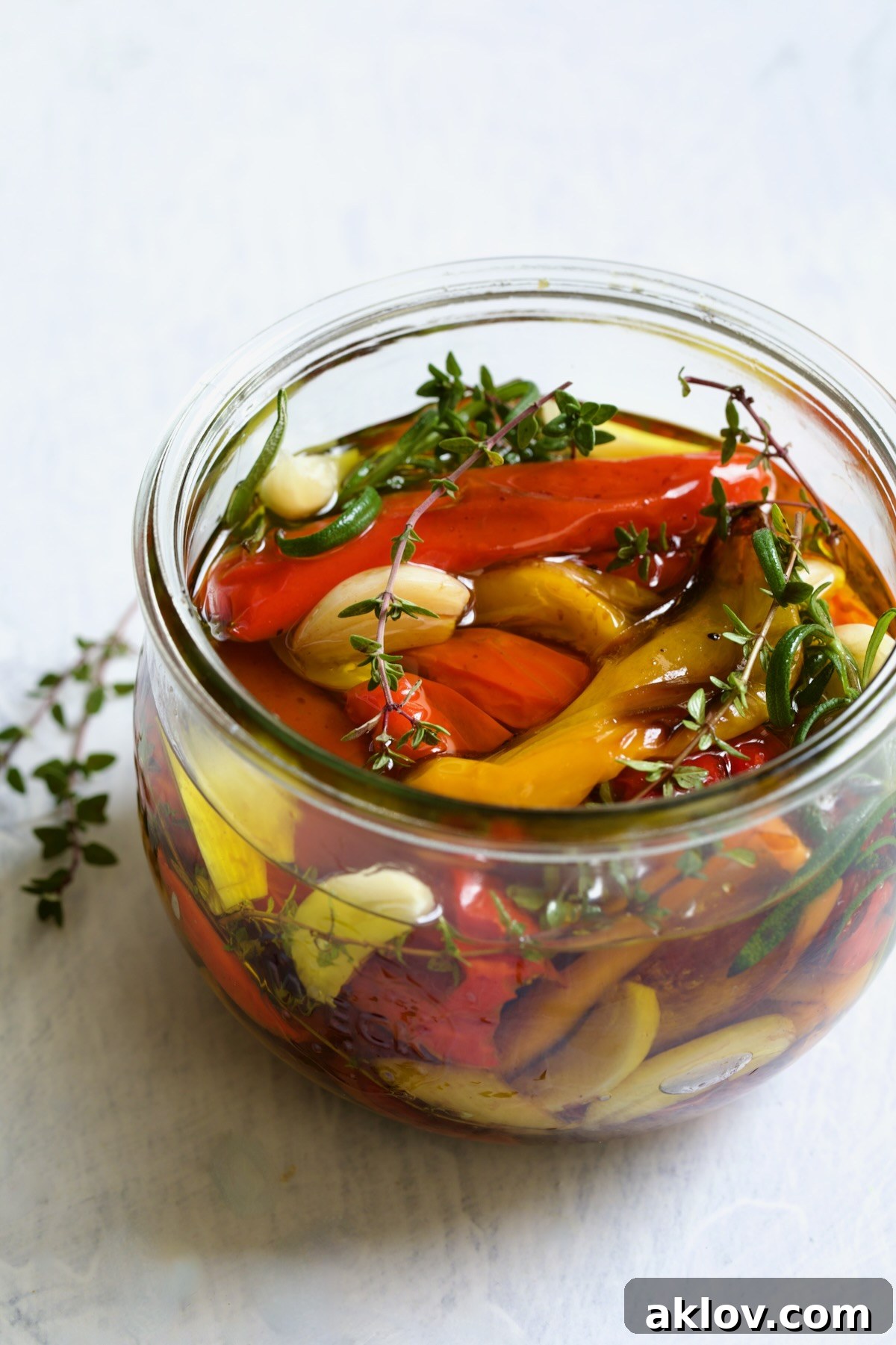 Caramelized Mini Peppers 3 Roasted Mini Peppers in glass jar with fresh herbs and garlic.