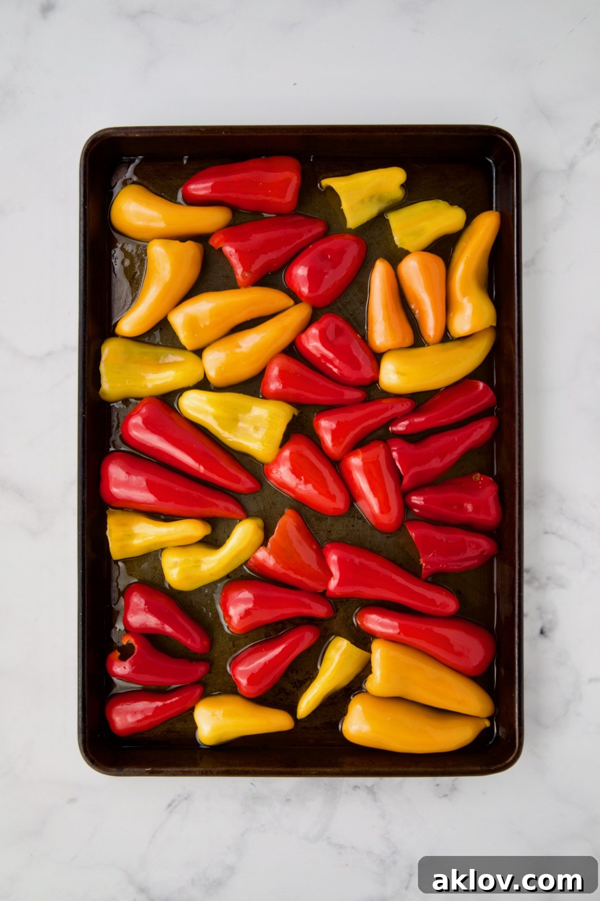 Caramelized Mini Peppers 5 Halved mini peppers before being roasted on rimmed sheet pan drizzled with olive oil.