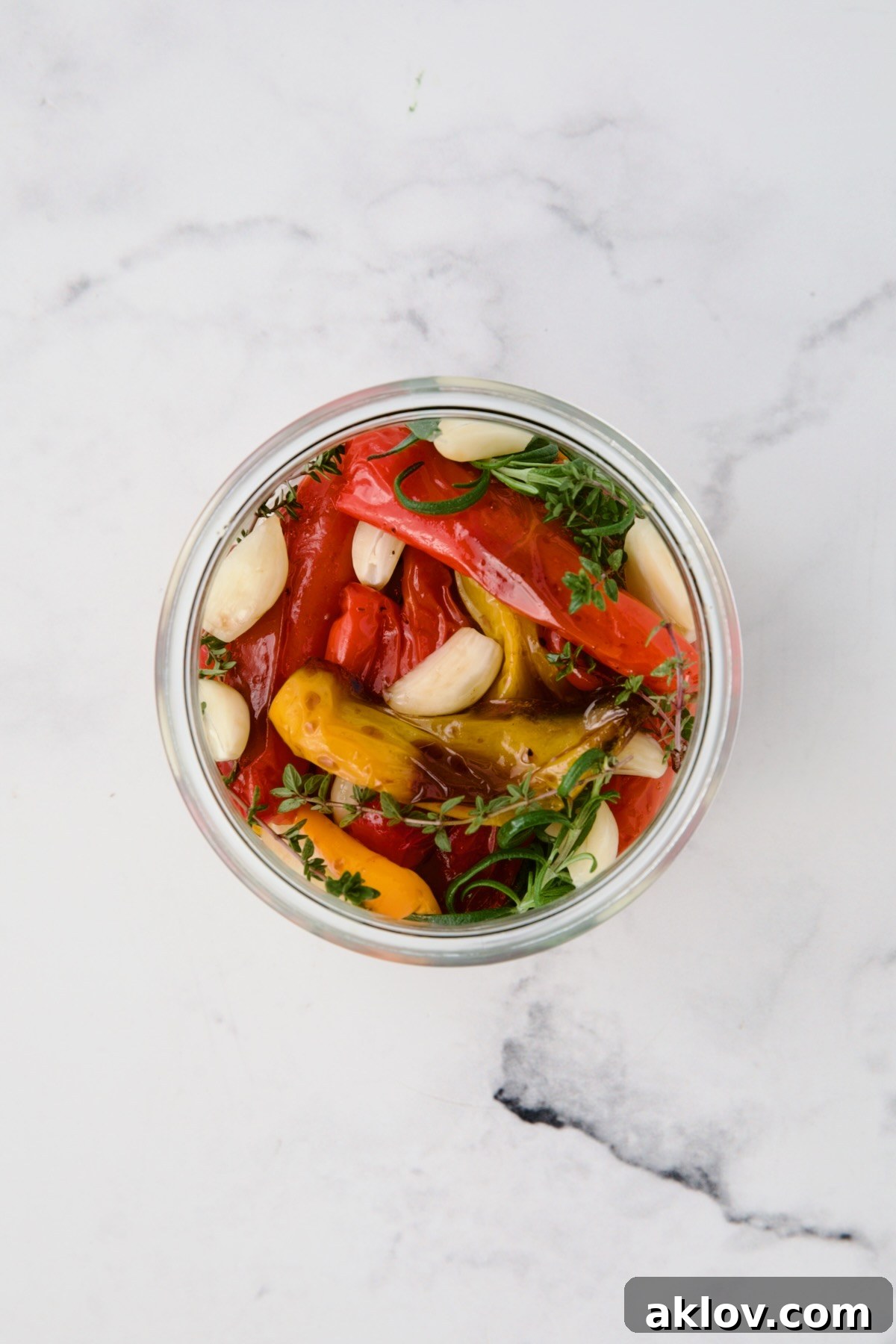 Caramelized Mini Peppers 6 Roasted mini peppers in glass jar before olive oil is added.