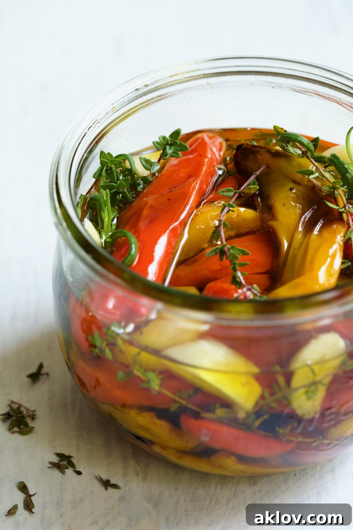 Caramelized Mini Peppers 8 Roasted Mini Peppers in glass jar with fresh herbs and garlic.