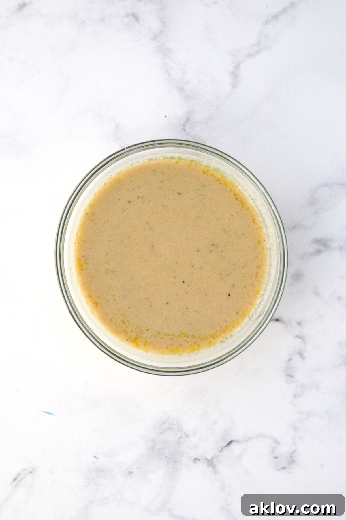 Lemon Tahini Dressing in glass bowl.