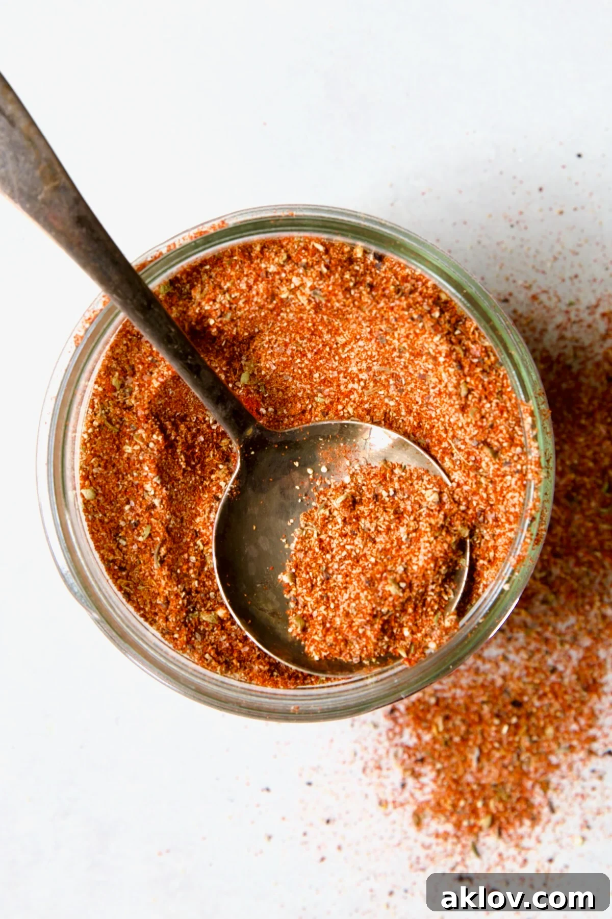 Jar of Blackening Seasoning with spoon scooping some out.