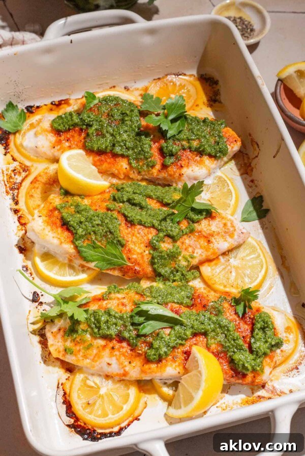 Baked Red Snapper with Zhoug, a healthy and gluten-free dinner recipe, garnished with fresh herbs.