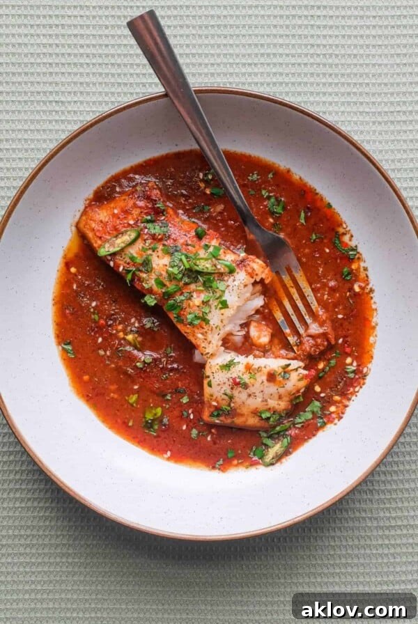 A close-up of Chraime Sauce with Fish, showcasing the rich, vibrant colors of the North African tomato sauce and flaky white fish.