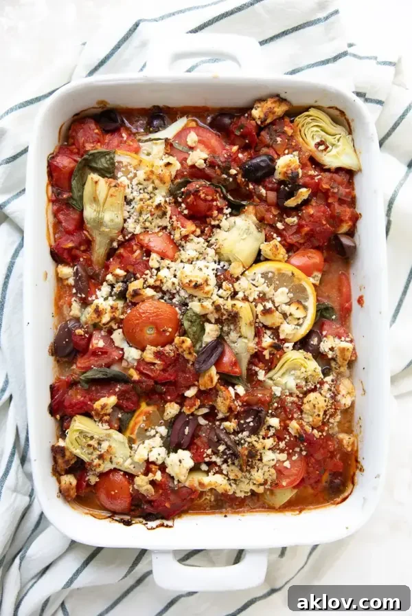 Mediterranean Baked Fish with Artichokes and Olives in a white rectangular baking dish, showcasing a healthy and flavorful meal.