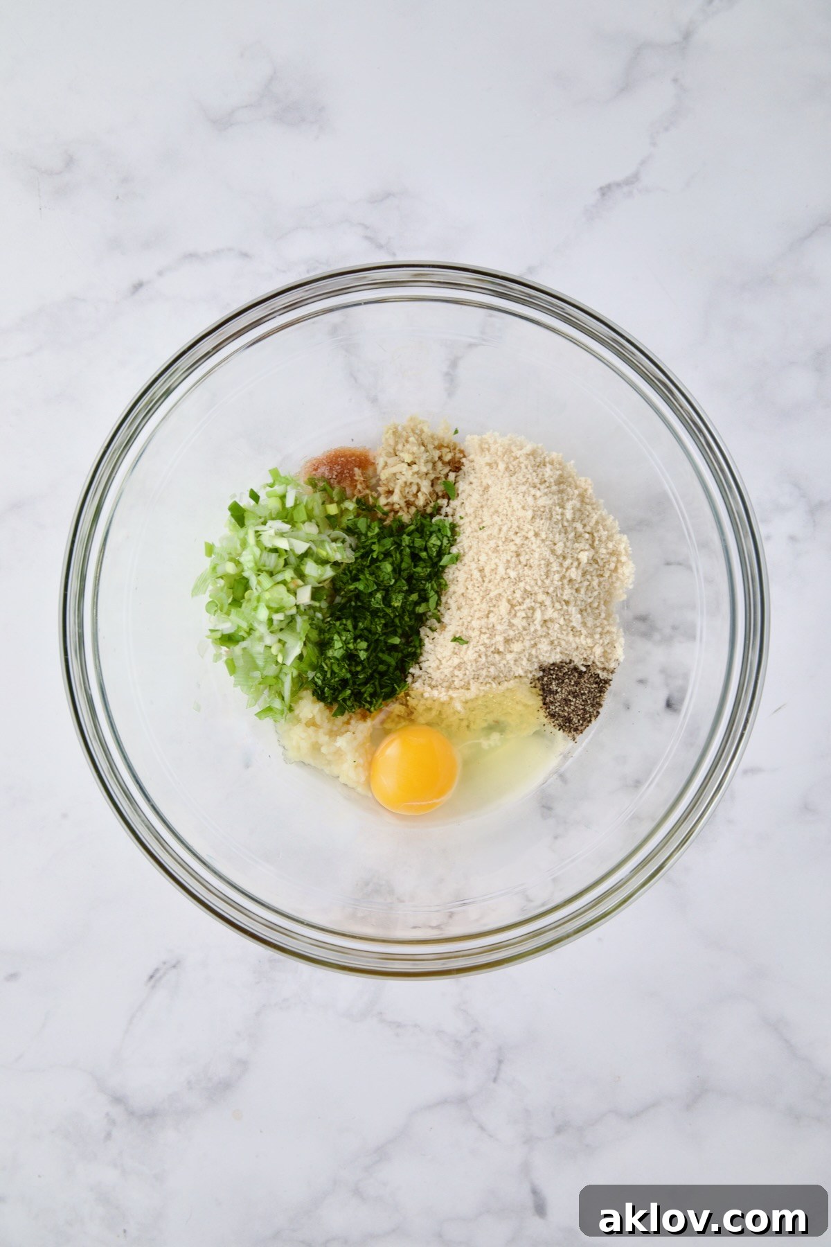 All meatball ingredients except ground turkey in a glass bowl, prior to mixing.
