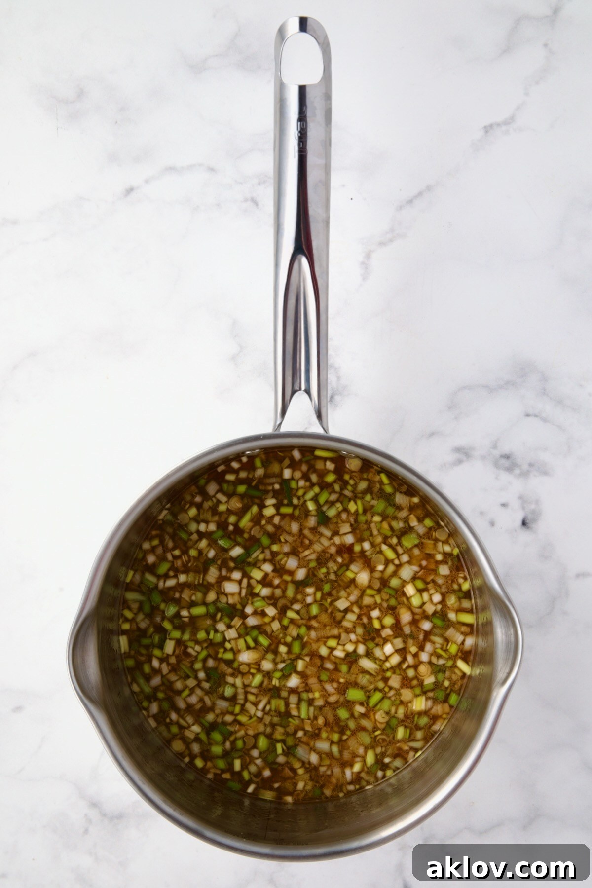 Ingredients for the Orange Sesame Sauce in a stainless steel saucepan, before simmering.