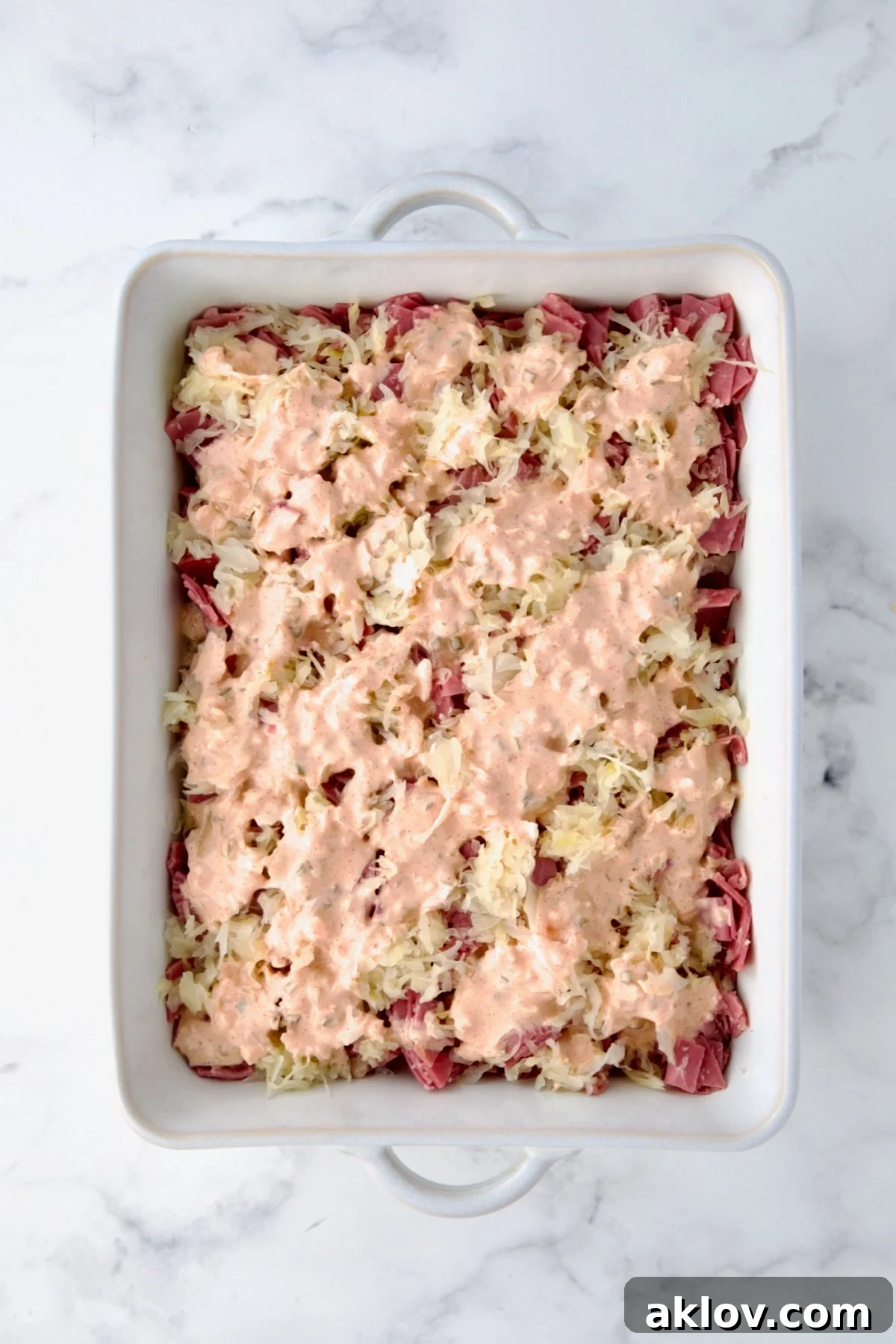 Creamy Reuben Comfort Casserole 14 Another drizzle of Thousand Island dressing applied over the second sauerkraut layer.
