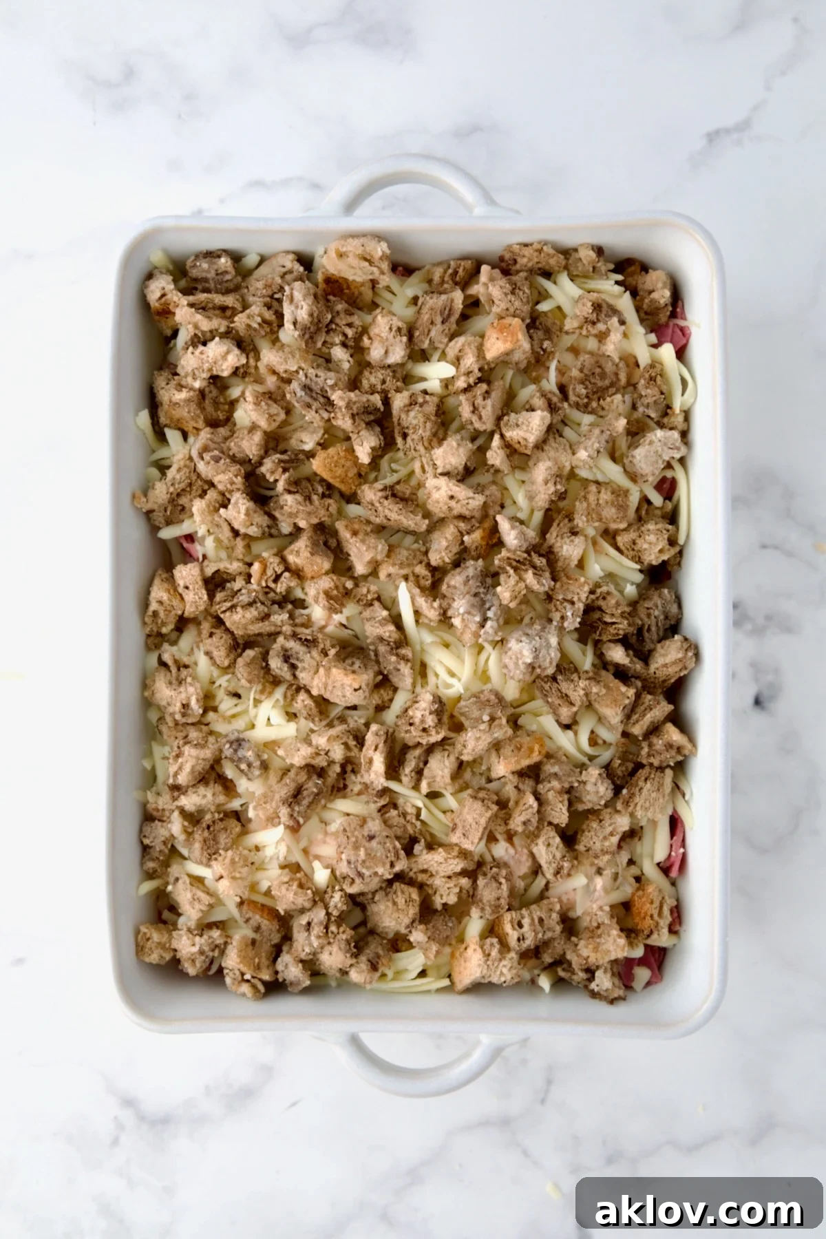 Creamy Reuben Comfort Casserole 16 The final layer of buttered bread cubes spread evenly over the Reuben Casserole, forming the delicious topping.