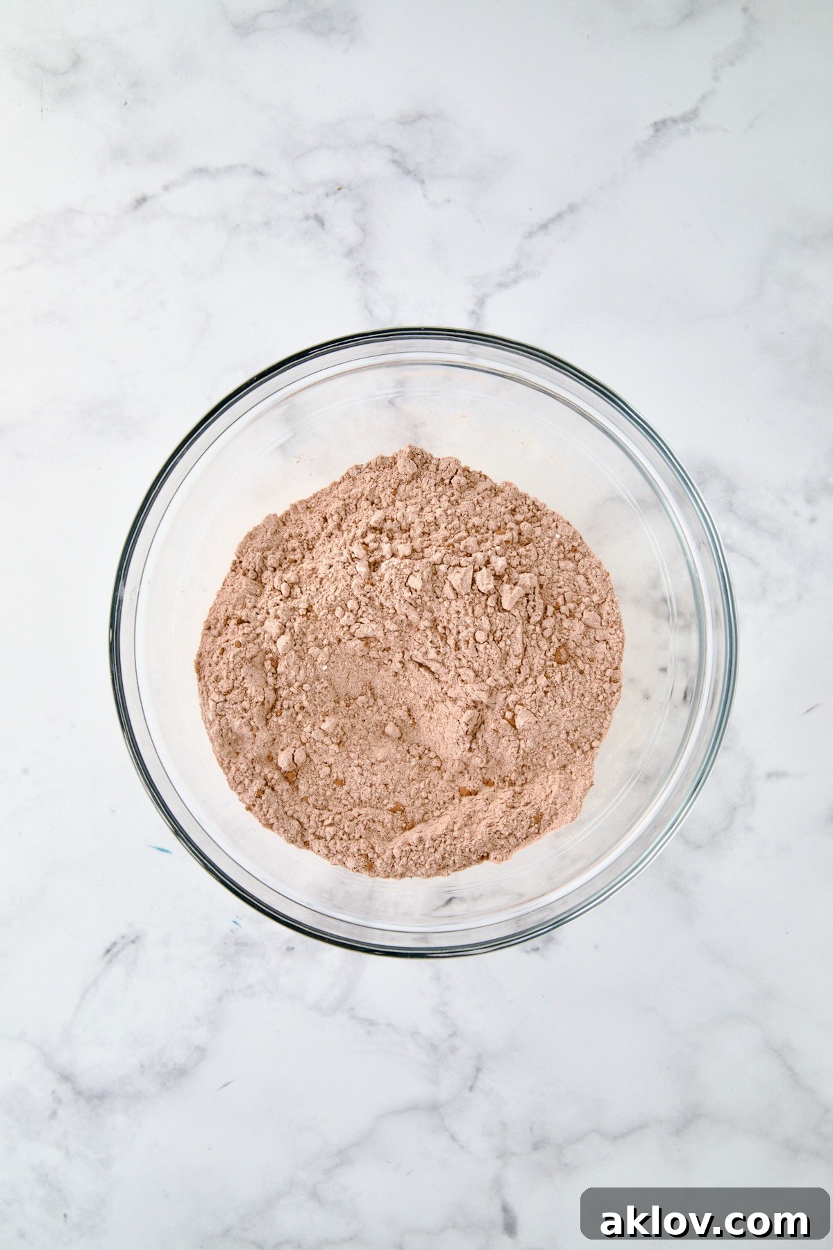 Dry ingredients for muffins in glass bowl.